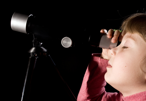 Discovery - a child using a telescope